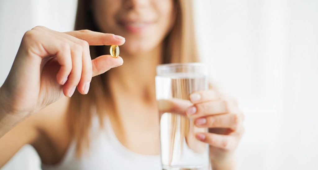 vitamins-supplements-woman-taking-tablet-close-up-hand-with-pill-mouth_118454-2850